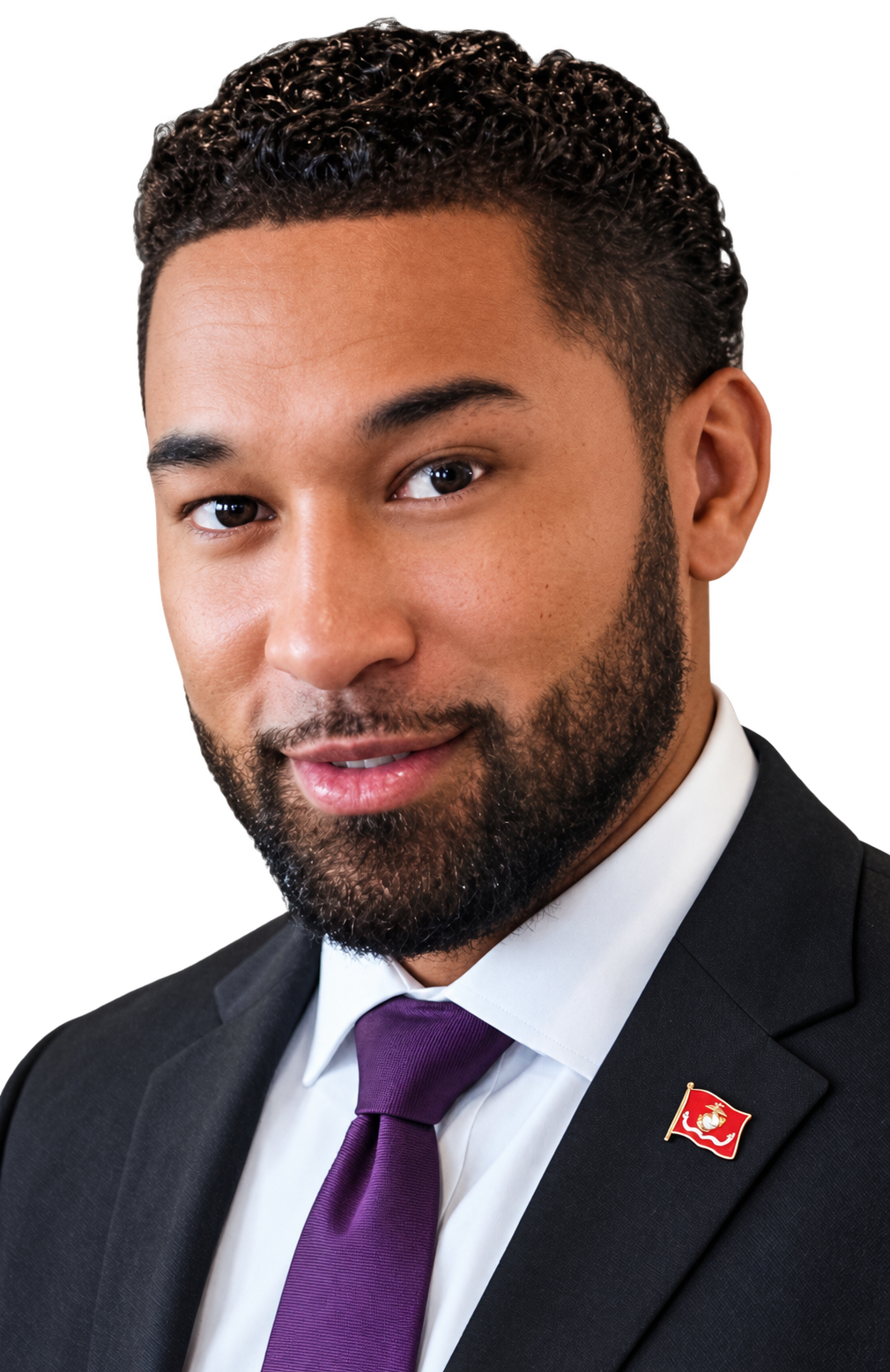 Dr. J. Jacob Martinez in a dark suit and purple tie, with his Marine Corps lapel pin visible